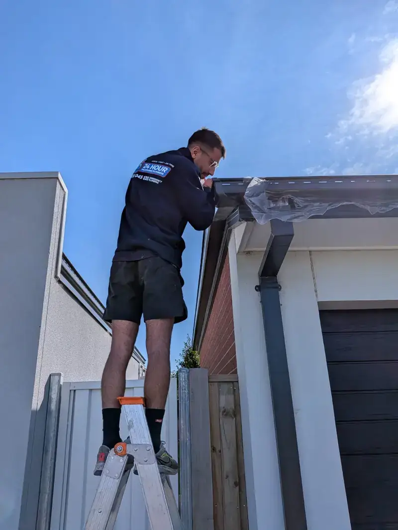 Roof plumber working on gutter in Chadstone